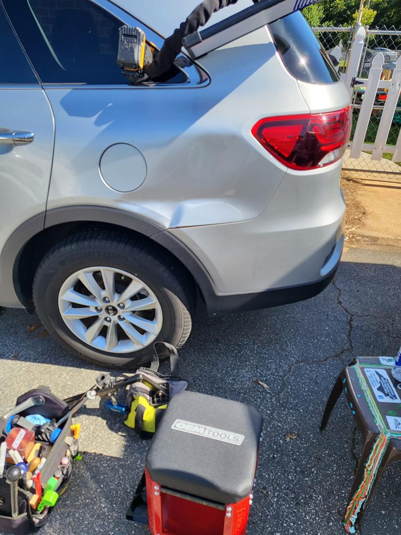 Before: quarter panel dent on gray SUV in Central NC