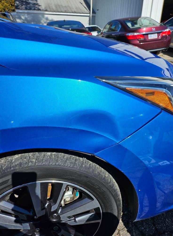 Before PDR painteless dent repair done on a blue luxury car